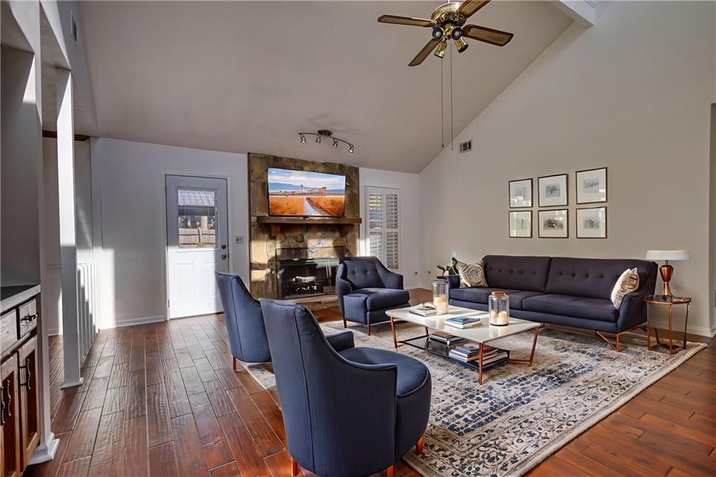 5113 Brownlee Road Southwest Lilburn, GA 30047 - Photo 3 of 48 a living room with furniture a rug and a flat screen tv