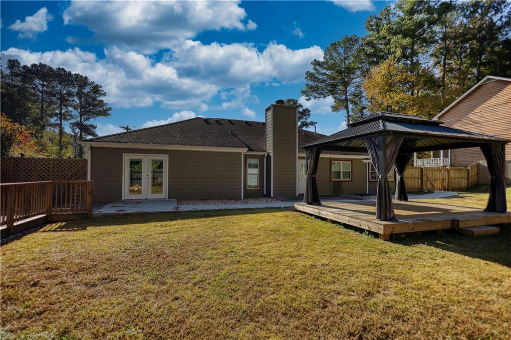 5113 Brownlee Road Southwest Lilburn, GA 30047 - Photo 32 of 48 a view of a house with backyard and porch