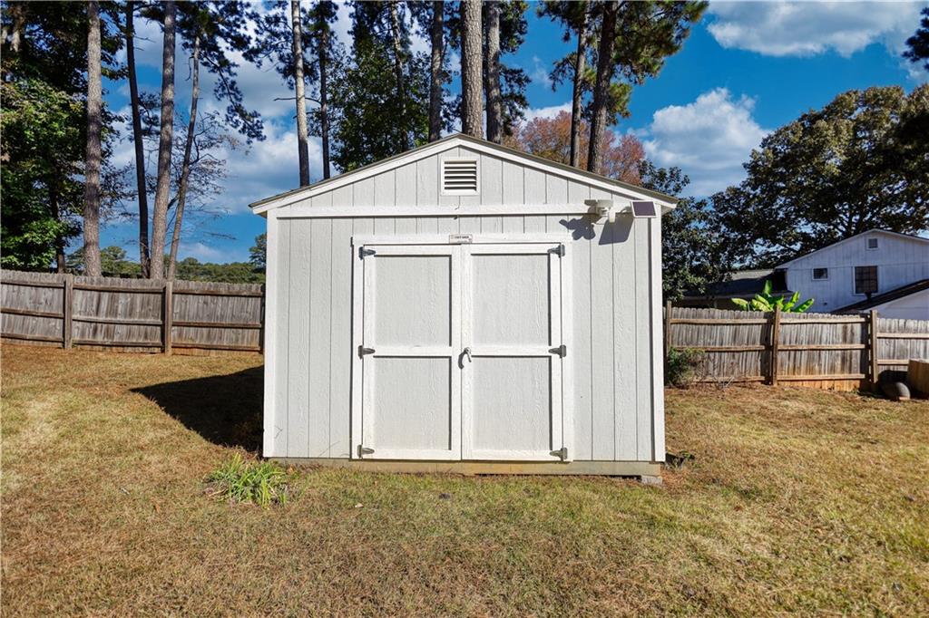 5113 Brownlee Road Southwest Lilburn, GA 30047 - Photo 35 of 48 a view of backyard with large tree