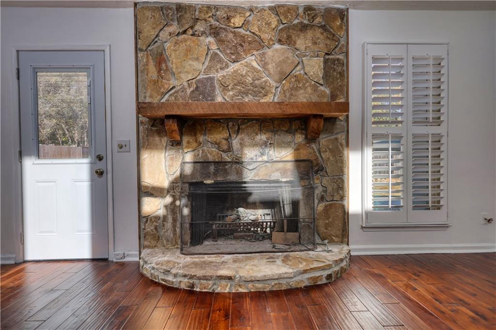 5113 Brownlee Road Southwest Lilburn, GA 30047 - Photo 4 of 48 a fireplace with wooden floor