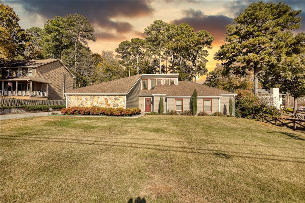 5113 Brownlee Road Southwest Lilburn, GA 30047 - Photo 47 of 48 a front view of a house with a garden