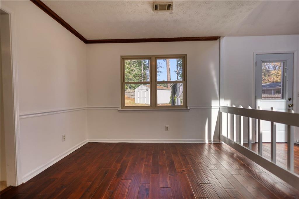 5113 Brownlee Road Southwest Lilburn, GA 30047 - Photo 7 of 48 wooden floor in an empty room with a window