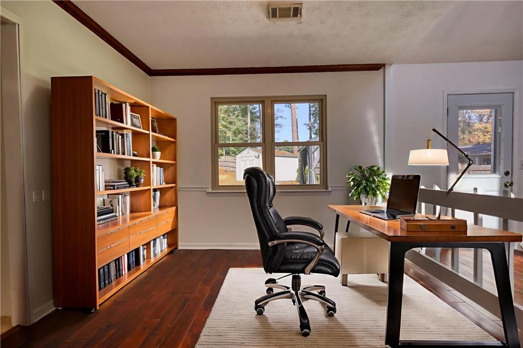 5113 Brownlee Road Southwest Lilburn, GA 30047 - Photo 8 of 48 a workspace with furniture window and wooden floor