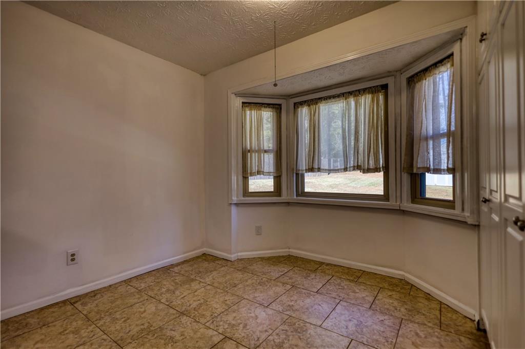 5113 Brownlee Road Southwest Lilburn, GA 30047 - Photo 10 of 48 a view of an empty room and window