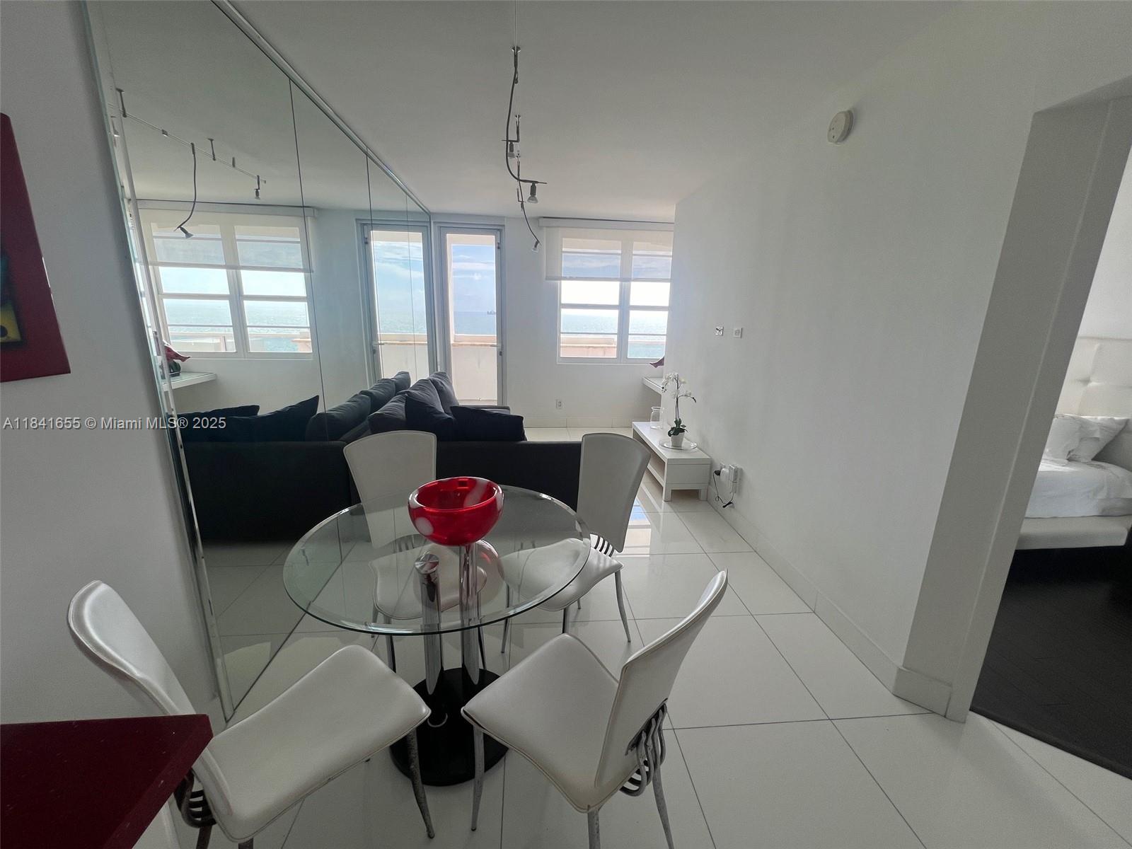 100 Lincoln Road, Unit 1419 Miami Beach, FL 33139 - Photo 11 of 57 a living room with furniture and wooden floor