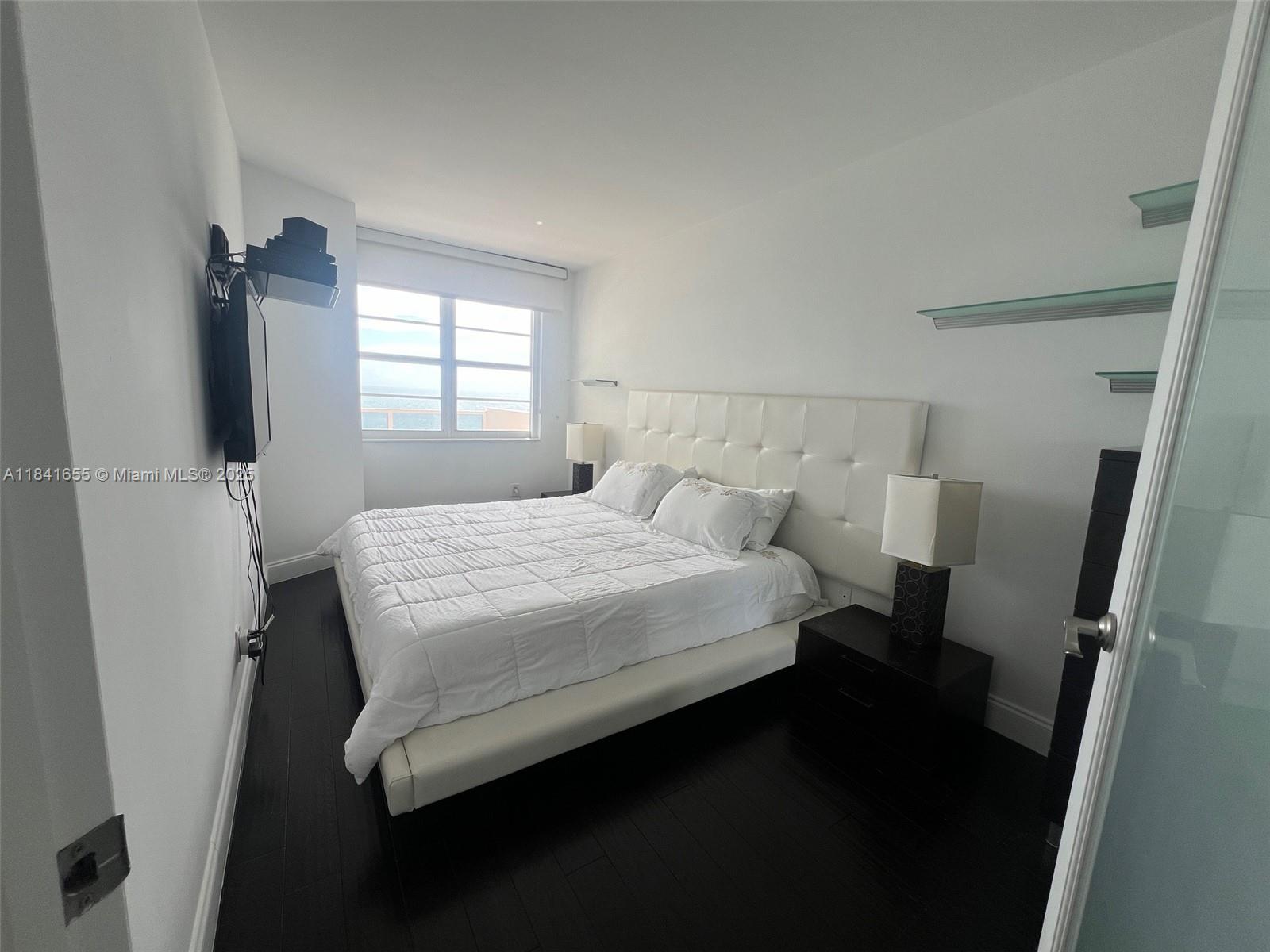 100 Lincoln Road, Unit 1419 Miami Beach, FL 33139 - Photo 14 of 57 a bedroom with a bed and a flat tv screen on the dresser