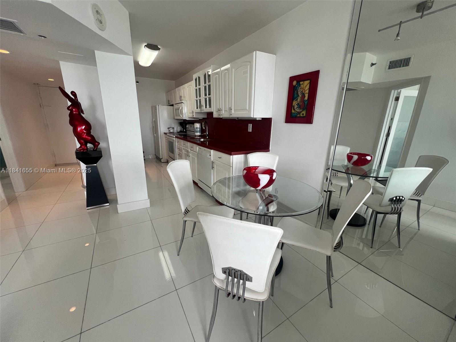100 Lincoln Road, Unit 1419 Miami Beach, FL 33139 - Photo 10 of 57 a view of a dining room with furniture and wooden floor