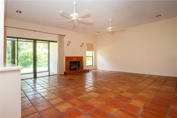 a view of empty room with fireplace and fan