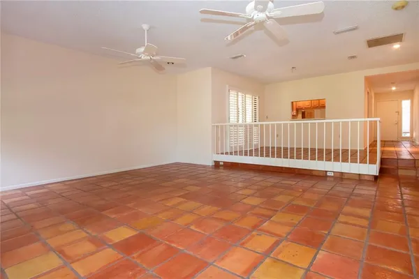 a view of a room with a ceiling fan and window