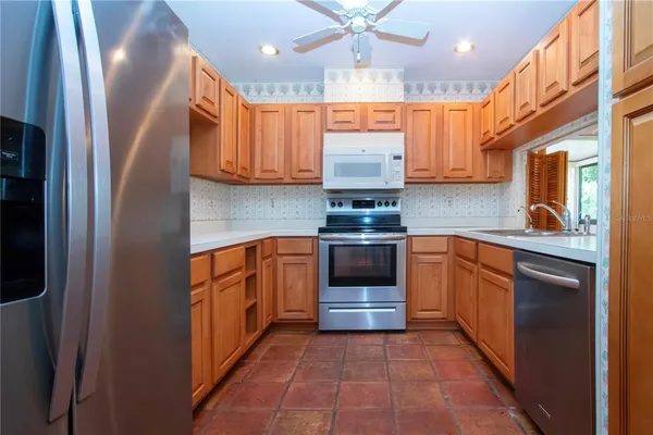 a kitchen with stainless steel appliances a sink and a refrigerator
