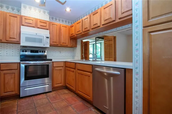 a kitchen with stainless steel appliances granite countertop a stove and a sink