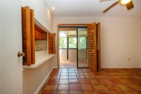 a view of a hallway with wooden floor and a bathroom