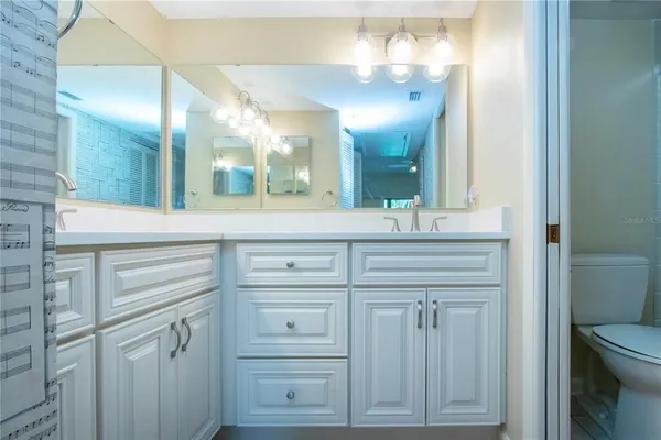 a bathroom with a sink vanity and a mirror