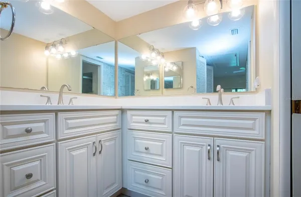 a bathroom with a sink vanity and a mirror