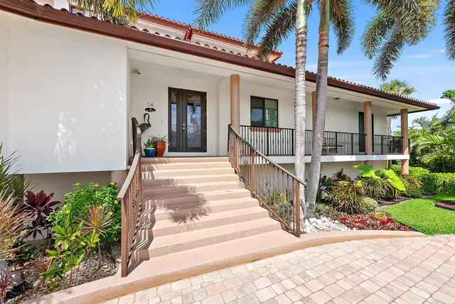 a large kitchen with stainless steel appliances granite countertop a stove a sink a dining table and chairs