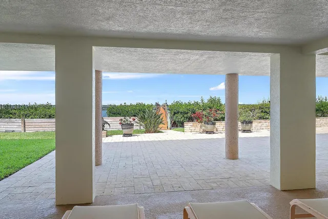 a dining room with furniture a chandelier and wooden floor