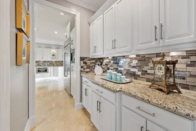 a bathroom with granite countertop double vanity and a large mirror