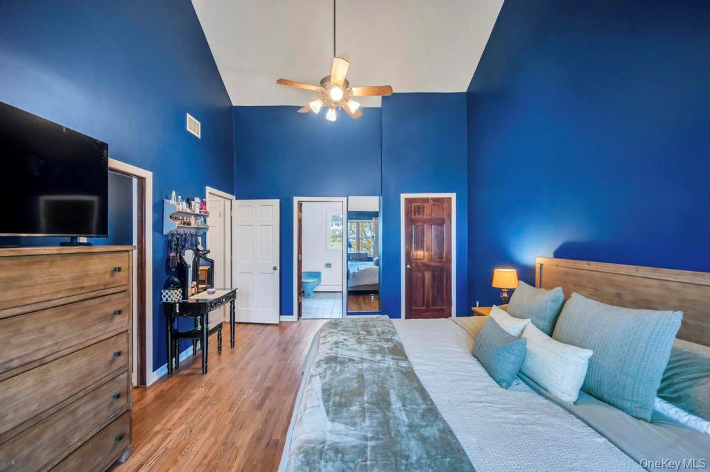 39 Bevin Road Northport, NY 11768 - Photo 30 of 44 Bedroom featuring high vaulted ceiling, wood finished floors, a closet, and ceiling fan