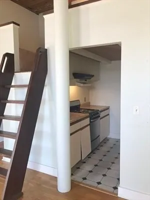 a kitchen with granite countertop a sink and a stove top oven