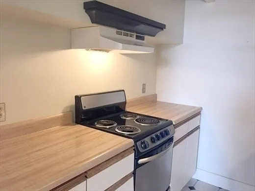a kitchen with a stove and a microwave