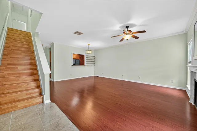wooden floor in an empty room with a window