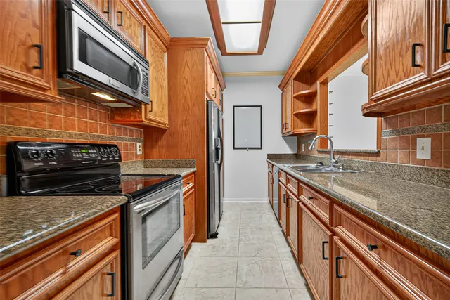 a kitchen with stainless steel appliances granite countertop a stove and a sink