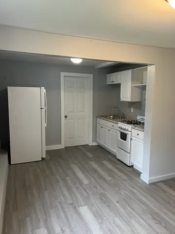 a kitchen with granite countertop a stove and a refrigerator