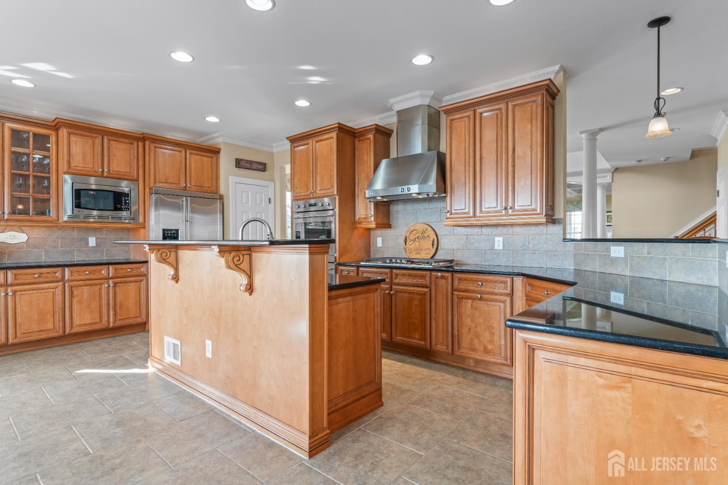 76 Raritan Reach Road South Amboy, NJ 08879 - Photo 36 of 69 a kitchen with stainless steel appliances granite countertop a refrigerator a sink dishwasher a oven and a dining table with wooden cabinets
