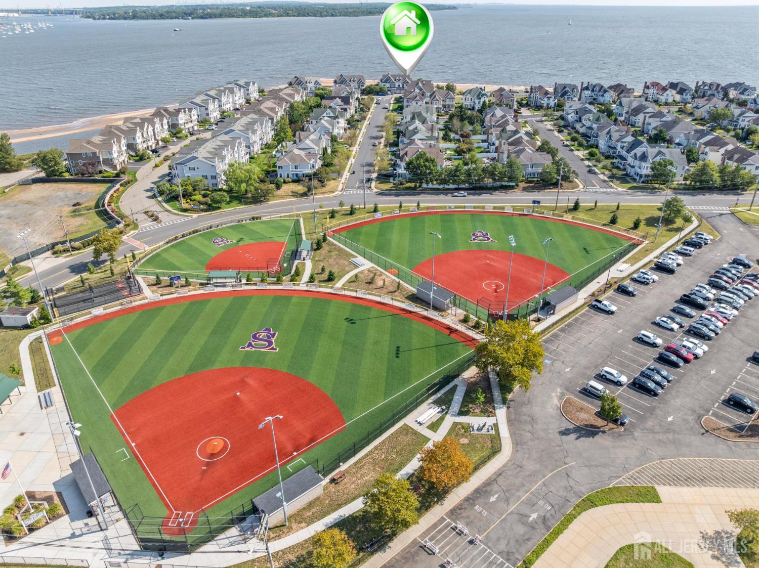 76 Raritan Reach Road South Amboy, NJ 08879 - Photo 8 of 69 an aerial view of a tennis ground and a cars park side of the road