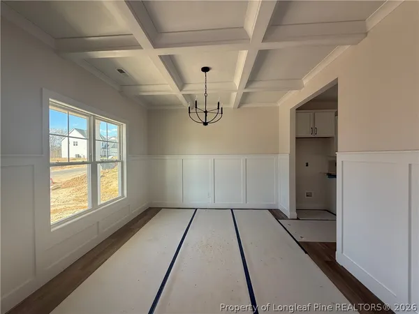 en empty room with wooden floor and windows