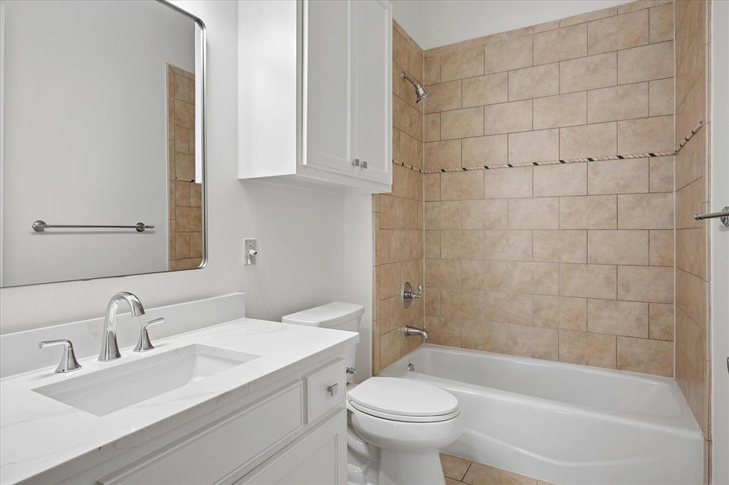 8511 Edgemere Road, Unit 102 Dallas, TX 75225 - Photo 14 of 17 a bathroom with a sink toilet and shower