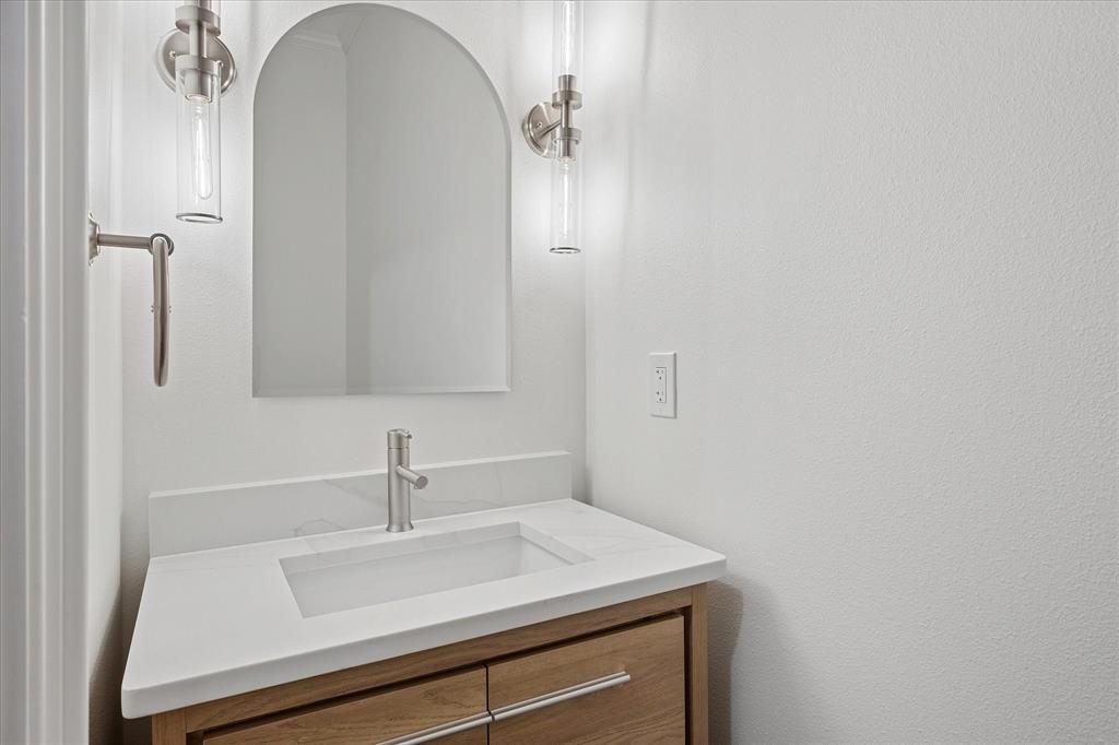 8511 Edgemere Road, Unit 102 Dallas, TX 75225 - Photo 15 of 17 a bathroom with a sink and a mirror