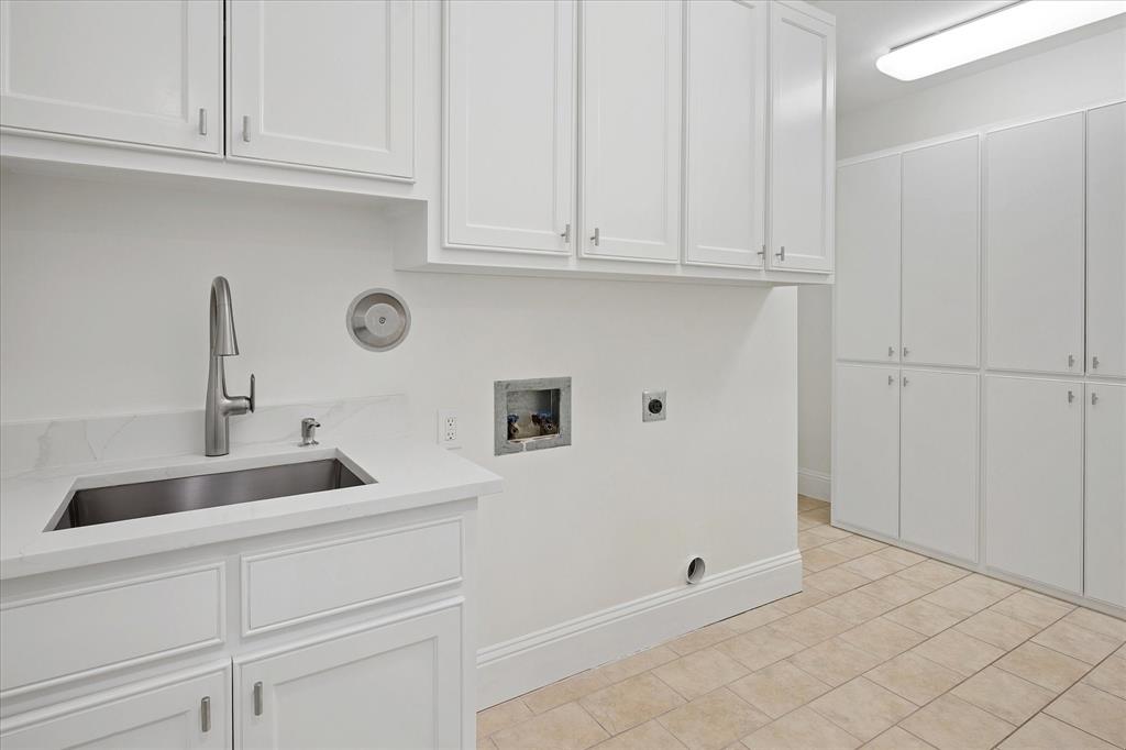 8511 Edgemere Road, Unit 102 Dallas, TX 75225 - Photo 16 of 17 a kitchen with white cabinets and sink