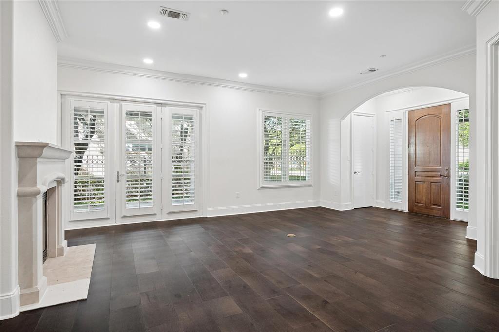 8511 Edgemere Road, Unit 102 Dallas, TX 75225 - Photo 2 of 17 an empty room with wooden floor and windows