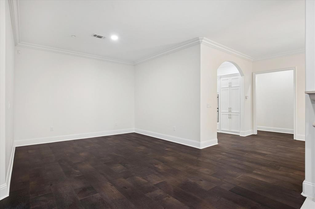 8511 Edgemere Road, Unit 102 Dallas, TX 75225 - Photo 5 of 17 an empty room with wooden floor and windows
