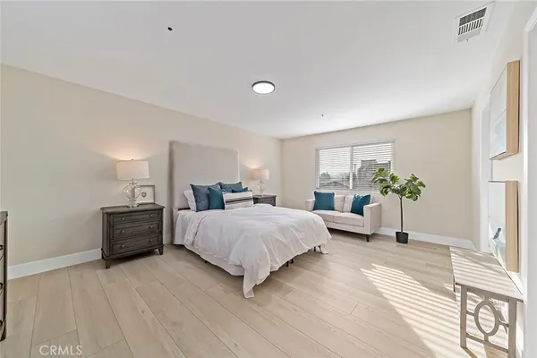 a bedroom with a bed and a potted plant