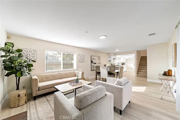 a living room with furniture and a potted plant