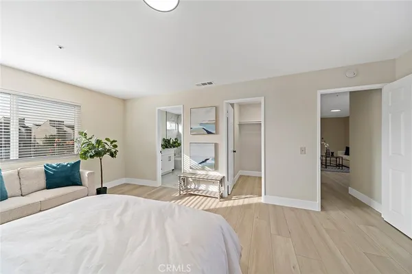 a bedroom with a bed and a couch