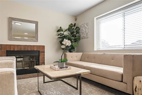 a living room with furniture and a fireplace
