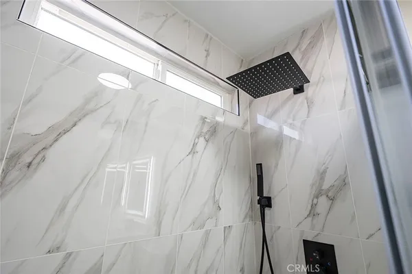 a bathroom with a shower and a shower
