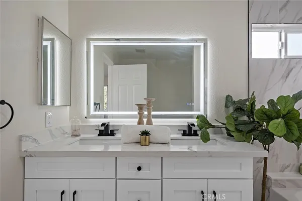 a bathroom with mirror and sink