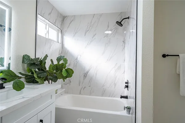 a bathroom with a sink a mirror and a bathtub