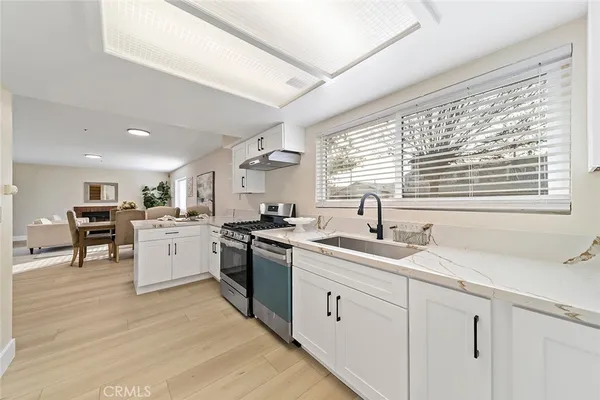 a kitchen with sink cabinets and appliances