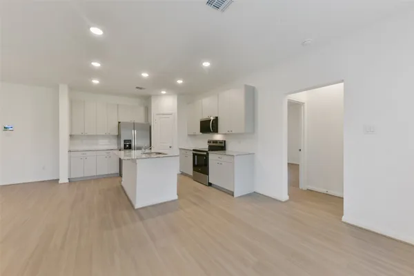 a view of kitchen with wooden floor