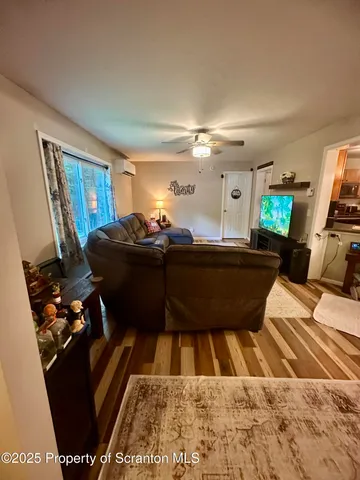 a view of a living room with furniture and a flat screen tv