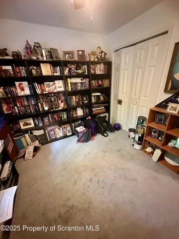 a bedroom with a bed a couch and a chandelier