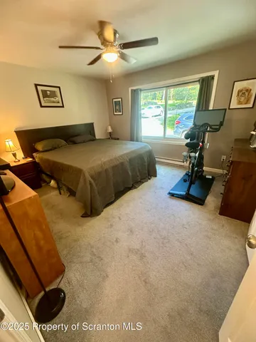 a bedroom with a bed window and dresser