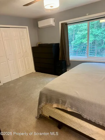 a bed room with two beds and a view of living room