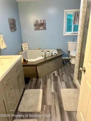 a bathroom with a sink mirror and a toilet
