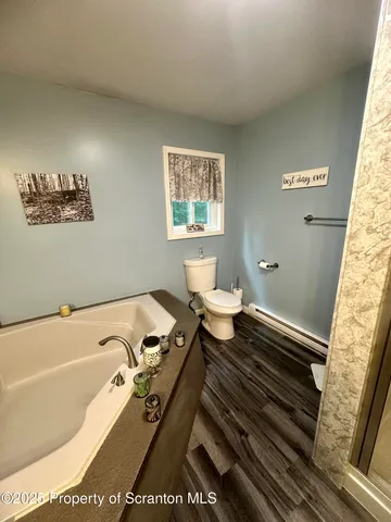 a bathroom with a glass shower door